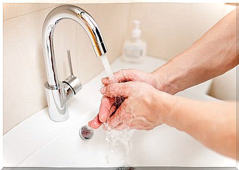 person washing the skin of hands