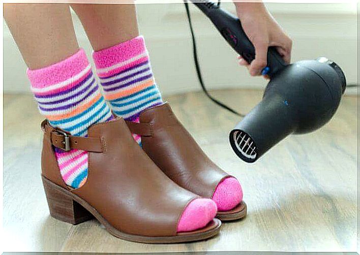 Apply dryer to shoes to loosen them