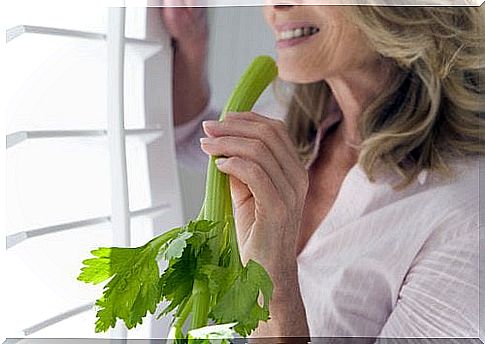 Woman eating celery