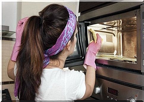 woman disinfecting the oven