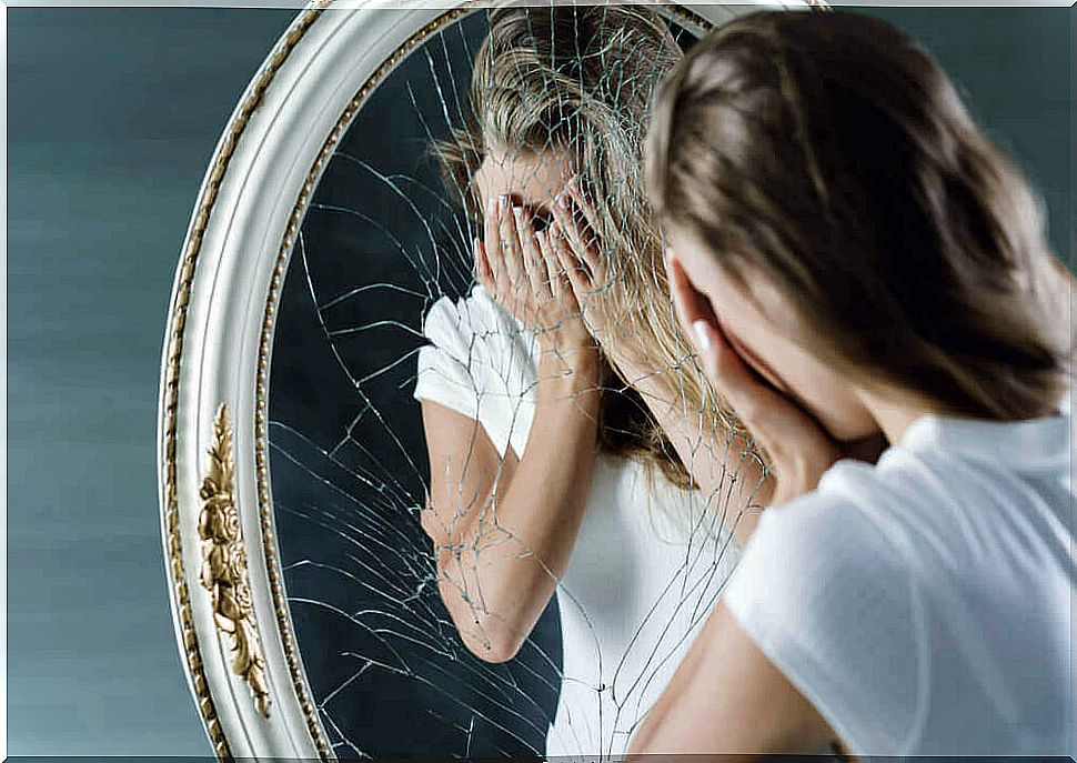 Lying woman looking at herself in the mirror ashamed