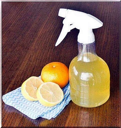 Cleaner in a spray bottle and oranges