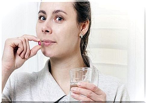 Woman taking iron supplement